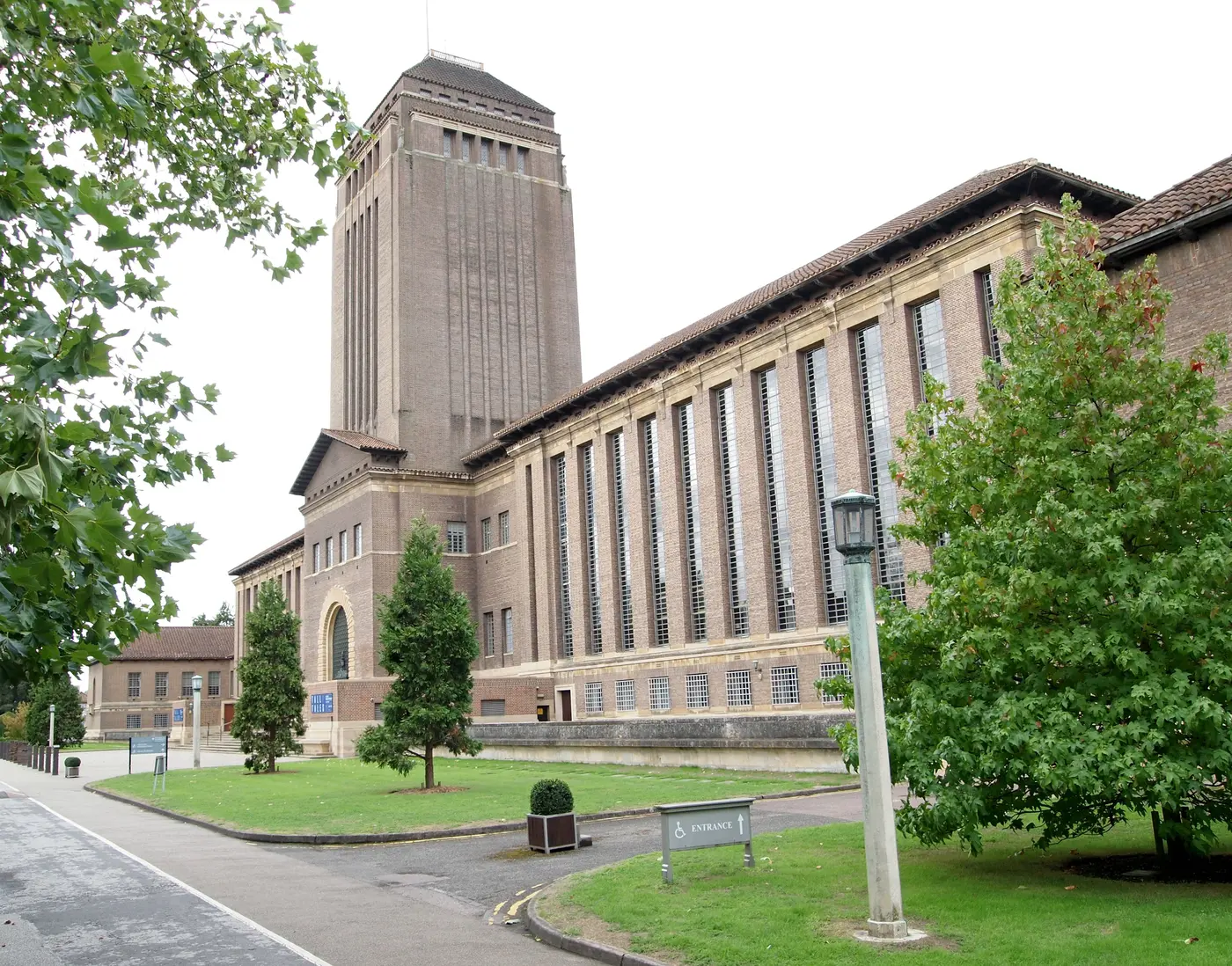 The Cambridge University Library tower and long brick frontage from West Road