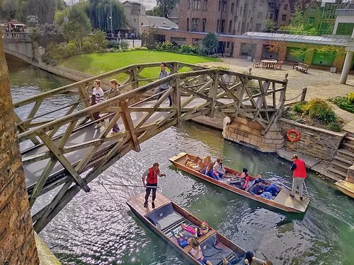 The timber Mathematical Bridge crossing the River Cam at Queens’ College, seen from the Riverside Building